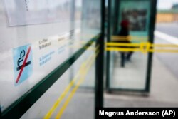 FILE - A no smoking sign is seen at a bus stop in Stockholm, Sweden, June 25, 2019. Sweden, which has the lowest rate of smoking in Europe is now close to declaring itself “smoke free,” defined as having less than 5% daily smokers in the population. (Magnus Andersson /TT News Agency via AP, File)