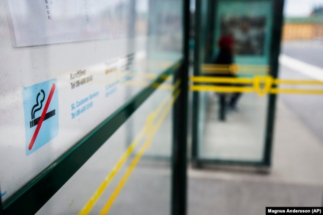 FILE - A no smoking sign is seen at a bus stop in Stockholm, Sweden, June 25, 2019. Sweden, which has the lowest rate of smoking in Europe is now close to declaring itself “smoke free,” defined as having less than 5% daily smokers in the population. (Magnus Andersson /TT News Agency via AP, File)