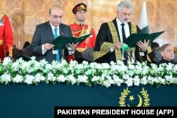 Supreme Court Chief Justice Qazi Faez Isa, 2nd right, administers oath to the newly sworn-in Pakistan's President Asif Ali Zardari, left, at the President House in Islamabad, March 10, 2024.