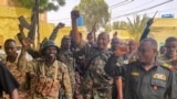 This picture released on the Sudanese Army's Facebook page on May 30, 2023, shows army chief Abdel Fattah al-Burhan cheering with soldiers as he visits some of their positions in Khartoum. AFP PHOTO / HO / SUDAN'S ARMED FORCES FACEBOOK PAGE