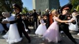Young Ukrainian cadets of Kyiv's "Cadets Corp" military school dance after the graduation ceremony at the Monument to Prince Volodymyr in Kyiv, amid Russian invasion of Ukraine.