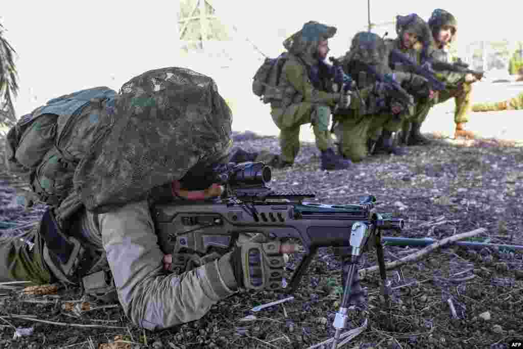 Israeli soldiers keep a position while troops train in the upper Galilee region of northern Israel near the border with Lebanon, amid increasing cross-border tensions between Hezbollah and Israel as fighting continues in the south with Hamas militants in the Gaza Strip.&nbsp;