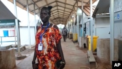 FILE - Elizabeth Nyachiew, a midwife supervisor with Doctors Without Borders walks through the hospital in Bentiu, South Sudan, June 24, 2024. South Sudan's health system suffers, even though relative peace in the country gives many women easier access to care.