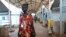 FILE - Elizabeth Nyachiew, a midwife supervisor with Doctors Without Borders walks through the hospital in Bentiu, South Sudan, June 24, 2024. South Sudan's health system suffers, even though relative peace in the country gives many women easier access to care.