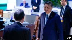 China's President Xi Jinping, right, arrives for the leaders retreat at the Asia-Pacific Economic Cooperation summit in San Francisco, California, Nov. 17, 2023.