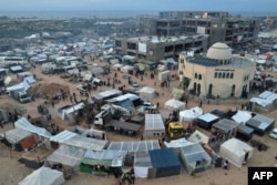 An aerial picture shows displaced Palestinians who fled Khan Yunis setting up camp in Rafah further south near the Gaza Strip's border with Egypt, Dec. 7, 2023.