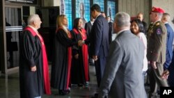 Venezuelan President Nicolas Maduro shakes hands with Supreme Court justices upon arrival to the Court in Caracas, Venezuela, Wednesday, July 31, 2024, three days after his disputed reelection.