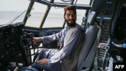 FILE - A Taliban fighter sits in an Afghan air force aircraft in Kabul, Aug. 31, 2021. The U.S. has given to Uzbekistan possession of aircraft that former Afghan air force personnel flew to Uzbekistan after the Taliban takeover.