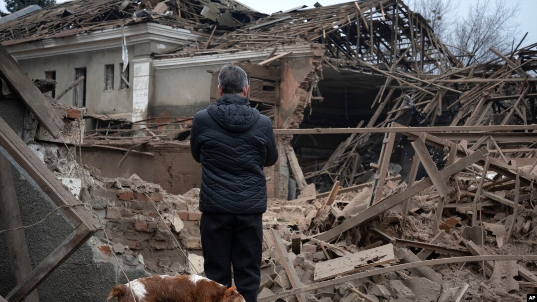 A resident looks at the remains of an industrial building after a Russian rocket attack in Sloviansk, Ukraine, Jan. 27, 2024. 