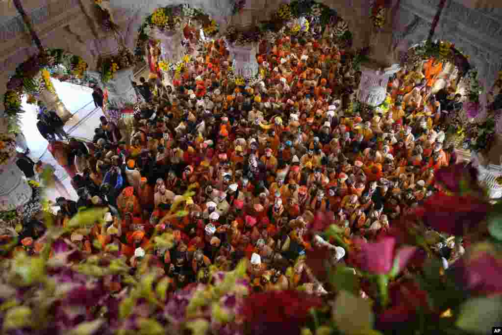 Hindu holy men gather to get the first look of the temple dedicated to Hinduism&rsquo;s Lord Ram soon after its opening in Ayodhya, India.&nbsp;Prime Minister Narendra Modi opened the Hindu temple built on the ruins of a historic mosque in the holy city of Ayodhya.