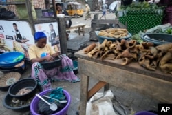FILE - A woman sells goods in Lagos, Nigeria, June 14, 2023. African Muslim leaders called for wider women's participation in public life.