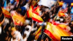 Supporters of Spain's opposition People's Party wave flags outside the party's headquarters on the day of the general election in Madrid, July 23, 2023.