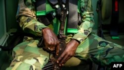 FILE - A U.N. peacekeeper holds his weapon while on patrol in Paoua, Central African Republic, Dec. 5, 2021.