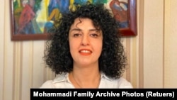 FILE -- Iranian human rights activist and vice president of the Defenders of Human Rights Center (DHRC) Narges Mohammadi poses in this undated handout picture. 
