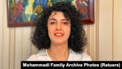 FILE - Iranian human rights activist Narges Mohammadi poses in this undated handout picture. 