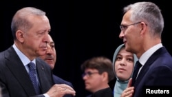 FILE - Turkey's President Recep Tayyip Erdogan and NATO Secretary General Jens Stoltenberg attend a NATO summit in Madrid, Spain, June 30, 2022.