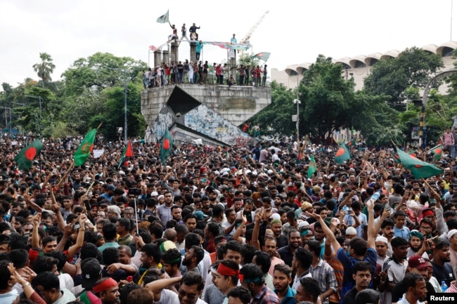 People celebrate the resignation of Bangladeshi Prime Minister Sheikh Hasina in Dhaka, Bangladesh, Aug. 5, 2024.