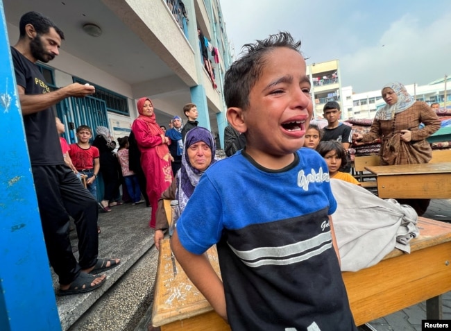 A Palestinian boy reacts at the damages at a U.N.-run school sheltering displaced people, following an Israeli strike, in Jabaliya in the northern Gaza Strip, Nov. 2, 2023.