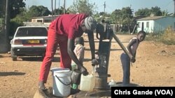 Residents of Sizinda, urban Bulawayo, Zimbabwe, fetching water from a borehole.