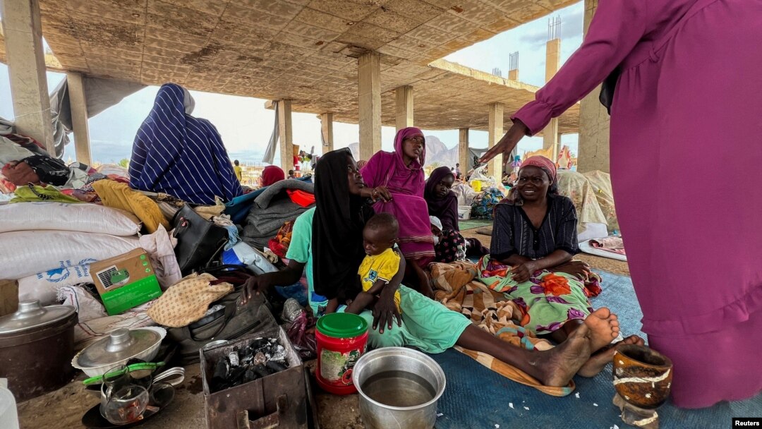FILE - Families displaced by RSF advances in Sudan's El Gezira and Sennar states shelter at the Omar ibn al-Khattab displacement site, Kassala state, Sudan, July 10, 2024. 
