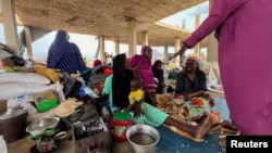 FILE - Families displaced by RSF advances in Sudan's El Gezira and Sennar states shelter at the Omar ibn al-Khattab displacement site, Kassala state, Sudan, July 10, 2024. 