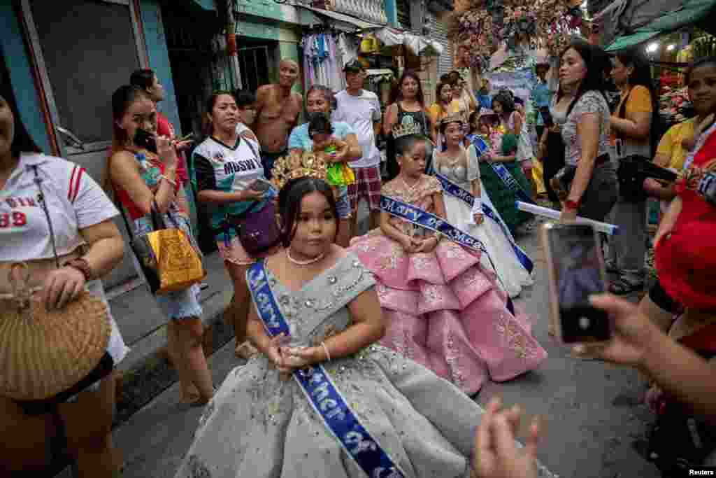 Girls take part in the Santacruzan parade, an annual Filipino Catholic tradition that celebrates the Holy Cross, in Tondo, Manila, Philippines.