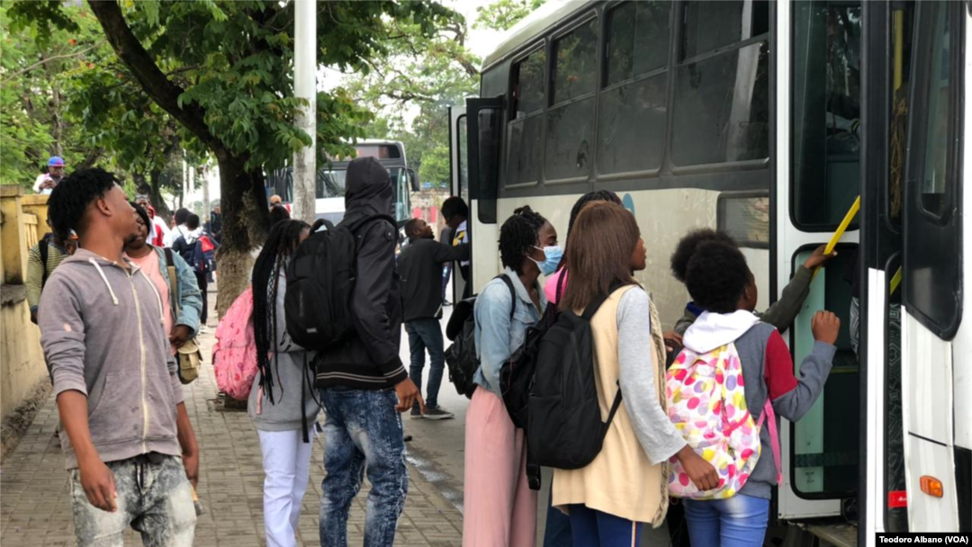 Cidadãos no Lubango, Angola, tentam subir um autocarro.