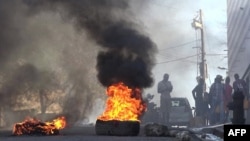 This screen grab taken from AFPTV shows tires on fire near the main prison in Port-au-Prince, Haiti, March 3, 2024, after several thousand inmates broke out of the facility.