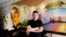 FILE - David Rasavong stands by a mural depicting his family's journey from Laos to San Francisco and then to Fresno, in his restaurant Love & Thai in Fresno, Calif. on Dec. 20, 2023. 