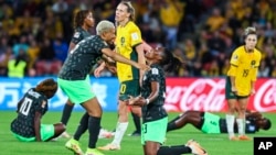 Nigeria's Onome Ebi, left, and Nigeria's Osinachi Ohale celebrate at the end of the Women's World Cup Group B soccer match between Australia and Nigeria In Brisbane, Australia, July 27, 2023. Ohale scored once and Nigeria won 3-2.