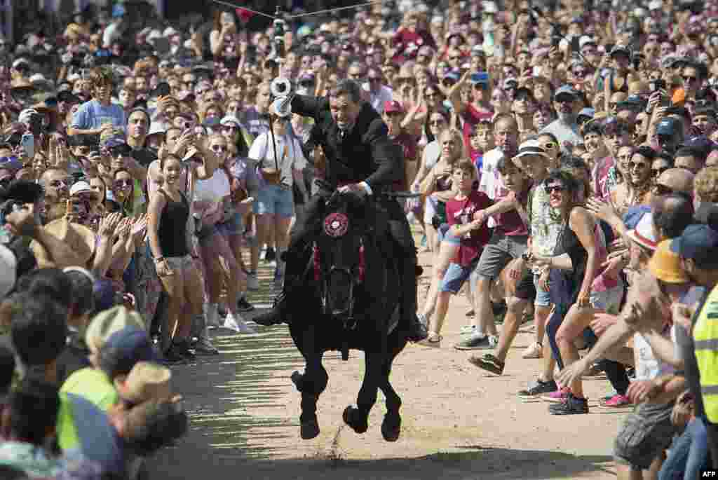 A rider gallops with a lance during the traditional San Juan (Saint John) festival in the town of Ciutadella, on the Balearic Island of Menorc, Spain, June 24, 2023.