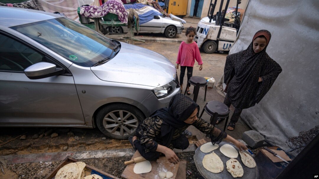 Palestinians displaced by the Israeli bombardment of the Gaza Strip prepare bread in a UNDP-provided tent camp in Khan Younis, Nov.15, 2023.