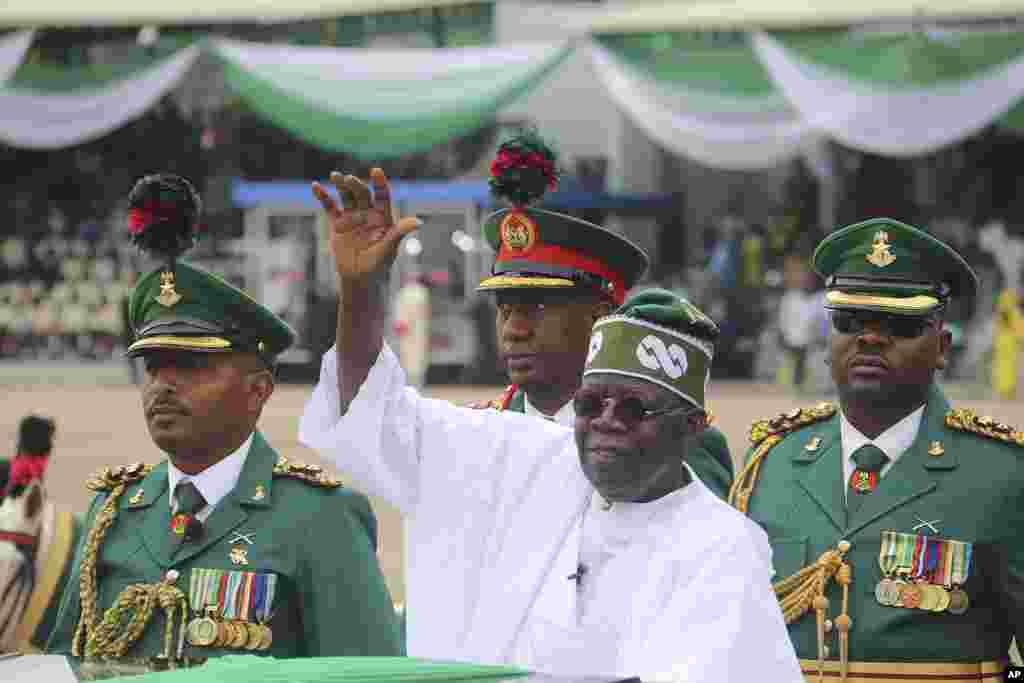 Nigeria's new President Bola Ahmed Tinubu inspects honor guards after taking an oath of office at a ceremony in Abuja, Nigeria, May 29, 2023.