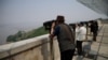 FILE - South Korean people look toward the North through binoculars at an observation post near the demilitarised zone separating two Koreas in Paju, South Korea, May 17, 2022. 