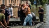 Local residents react after evacuation from a flooded area after the Kakhovka dam breached, in Kherson, Ukraine, June 9, 2023. 
