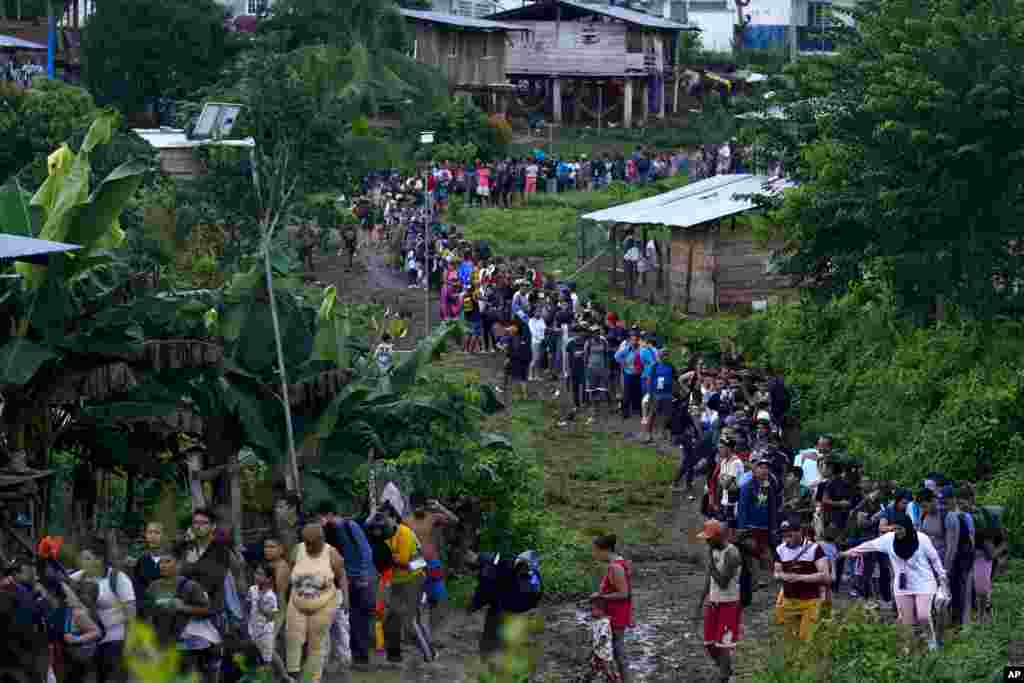 Migrants heading north line up to take a boat in Bajo Chiquito in the Darien province of Panama, after walking across the Darien Gap from Colombia. (AP Photo/Arnulfo Franco)