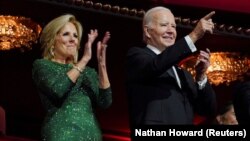 Presiden AS Joe Biden mengacungkan jari dan Ibu Negara Jill Biden bertepuk tangan saat menghadiri penghargaan Kennedy Center Honors ke-46, di Kennedy Center di Washington, AS, 3 Desember 2023. (Foto: REUTERS/Nathan Howard)