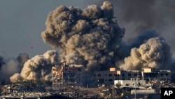 FILE — Smoke rises following an Israeli bombardment in the Gaza Strip, Dec. 16, 2023. South Africa has launched a case at the United Nations' top court alleging that Israel's military campaign in Gaza amounts to genocide.
