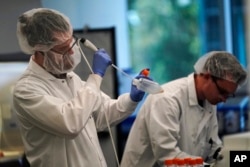 Scientists work in a bioprocess lab at Eat Just in Alameda, California, June 14, 2023.