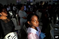 A girl attends Sunday Mass at a church In Dili, East Timor, Aug. 11, 2024.