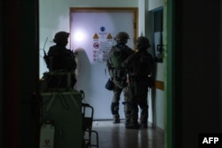 This handout picture released by the Israeli Army on Nov. 15, 2023, reportedly shows Israeli soldiers carrying out operations inside Shifa Hospital in Gaza City.
