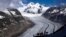 FILE - People enjoy the view at the Aletsch Glacier near Goms, Switzerland, on June 14, 2023. Swiss glaciers have lost 10% of their volume since 2021, and some glaciers are predicted to disappear entirely in the next few years.