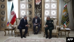A handout picture provide by the Iranian Army media office shows Iran's army Chief of Staff Mohammad Bagheri, right, greeting Russia's Security Council Secretary Sergei Shoigu, in Tehran, Aug. 5, 2024. 