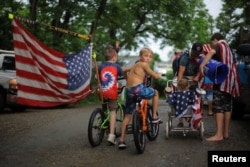 FILE - Boys on bikes lead residents' local Fourth of July Parade in the Lanesville neighborhood of Gloucester, Massachusetts, July 4, 2023. (REUTERS/Brian Snyder)