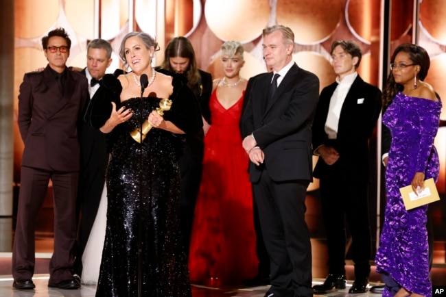 FILE - Producer Emma Thomas, foreground left, accepting the award for best motion picture drama for "Oppenheimer" as others look on during the 81st Annual Golden Globe Awards in Beverly Hills, Calif., on Sunday, Jan. 7, 2024. (Sonja Flemming/CBS via AP)