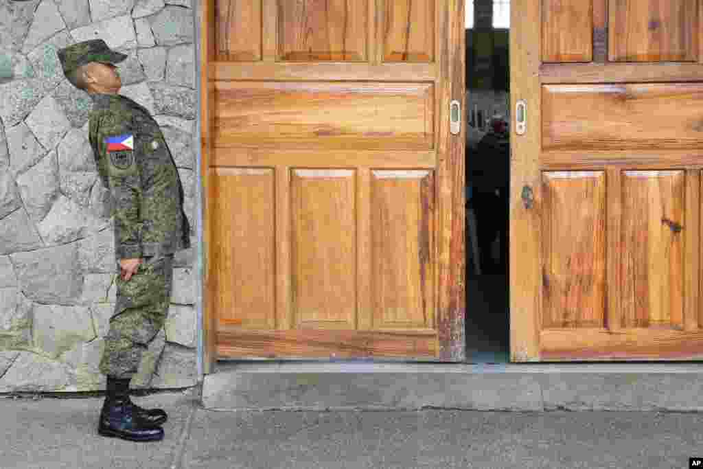 A cadet of the Philippine Military Academy stands at attention outside a hall at Fort Gregorio Del Pilar in Baguio, northern Philippines.