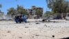 (FILE) The wreckage of a suicide car explosion after al-Shabaab militia stormed a government building in Somalia.