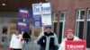 FILE - Candidate supporters stand outside a polling location in the presidential primary election, Jan. 23, 2024, in Windham, New Hampshire. Super Tuesday is feeling anything but for many Americans, with the leading presidential contenders already appearing set.