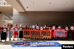 Climate activists protest during the United Nations Climate Change Conference COP28 in Dubai, United Arab Emirates, Dec. 10, 2023.