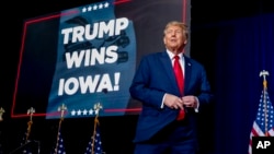 Republican presidential candidate and former President Donald Trump takes the stage at a caucus night party in Des Moines, Iowa, Jan. 15, 2024.